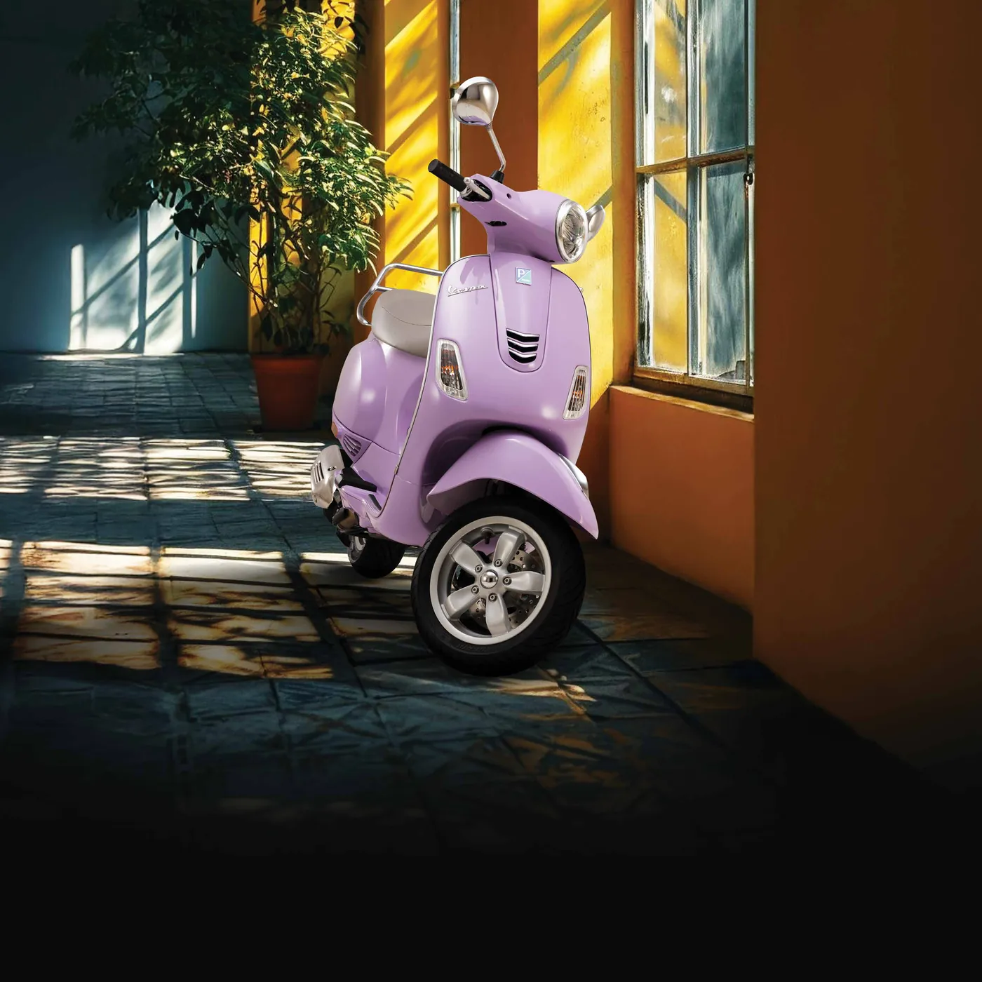 Lilac Vespa parked in a sunlit hallway